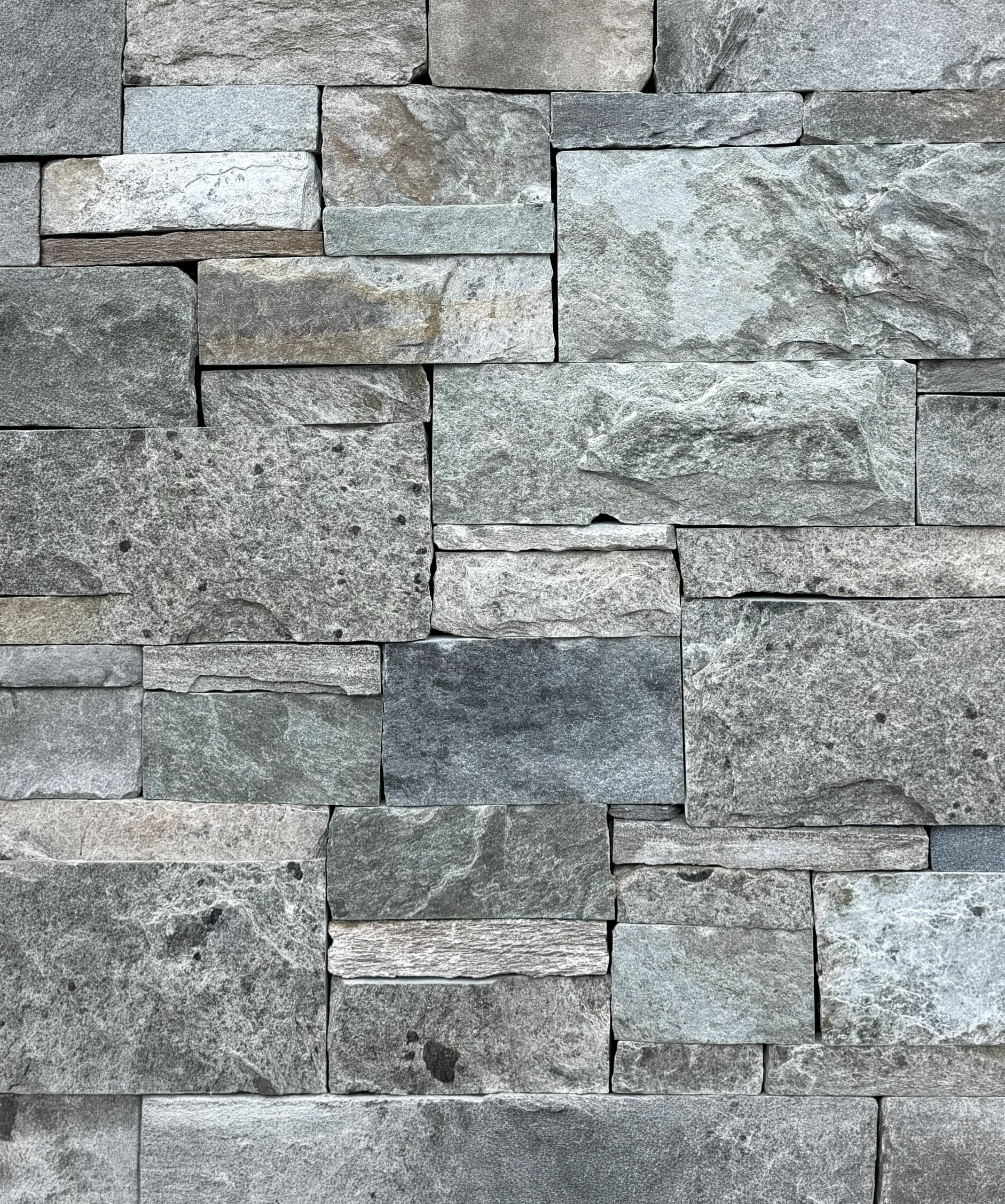 Actual Piedmont natural stone veneer showing silver, blue-gray, charcoal, and subtle earth tones